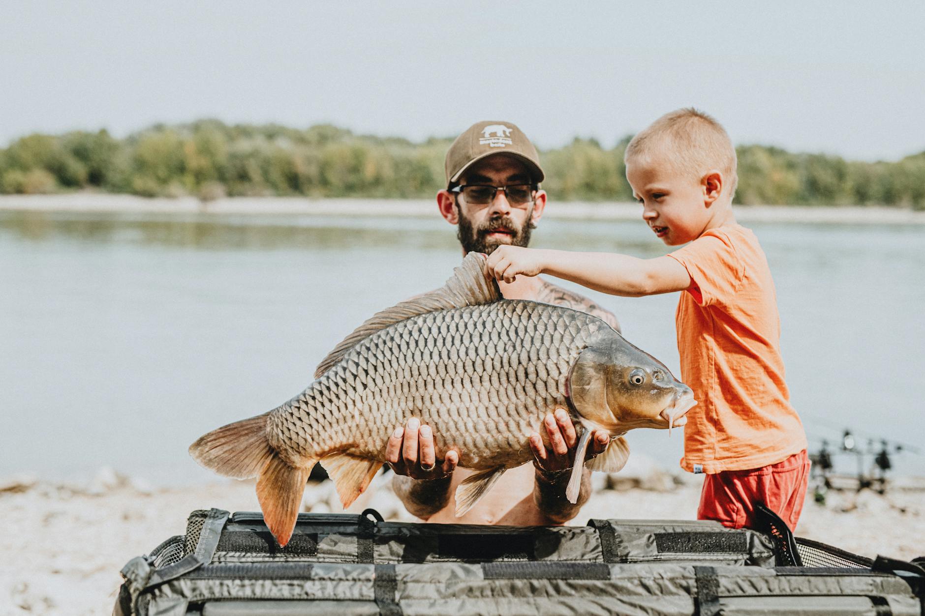 father and son holding a fish