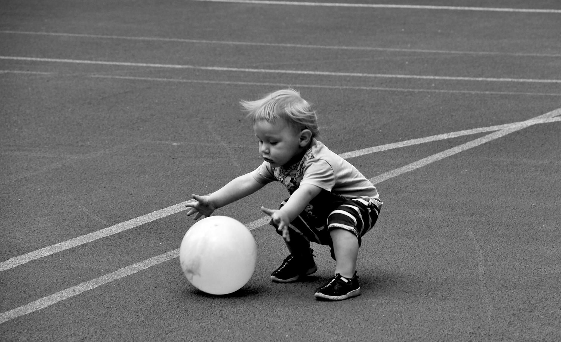 a young boy playing balloon